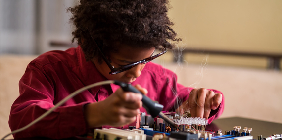 Child soldering.