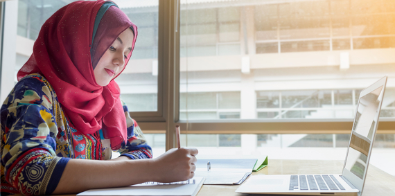 Young person studying in the library.